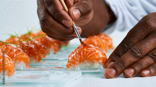 Chef Decorating Gourmet Seafood Dish with Precision