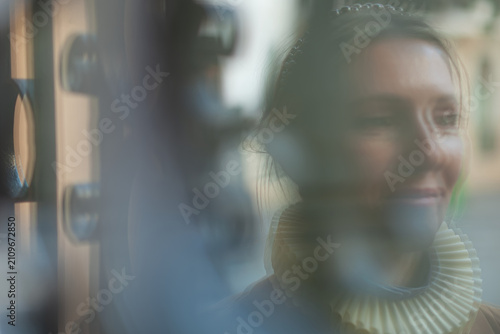 Obraz na płótnie A person face with an indistinct expression viewed through blurred glass creatin