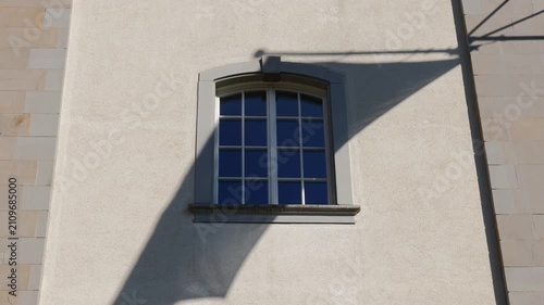 Old Building with Window and Shadow of a Flag Waving in the Wind in a Sunny Day in City of St Gallen, St Gallen Canton, Switzerland.