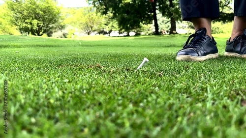 Golfer Picking Up Her Tee From the Grass on the Golf Course in a Sunny Summer Day in Switzerland. (Slow Motion)