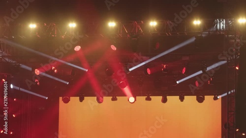 Red stage spotlights and lighting truss at outdoor concert