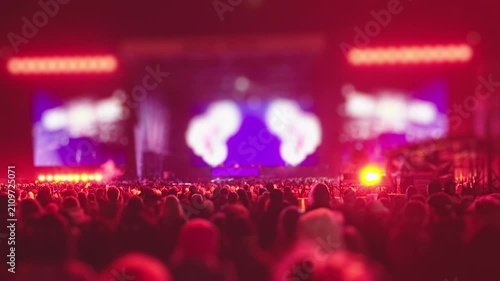 People attending outdoor concert with glowing festival atmosphere