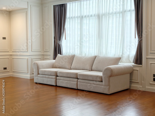 Modern beige fabric sofa set in bright living room interior