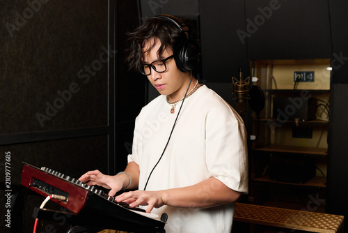 Photography Creative young man crafting music in a recording studio setting