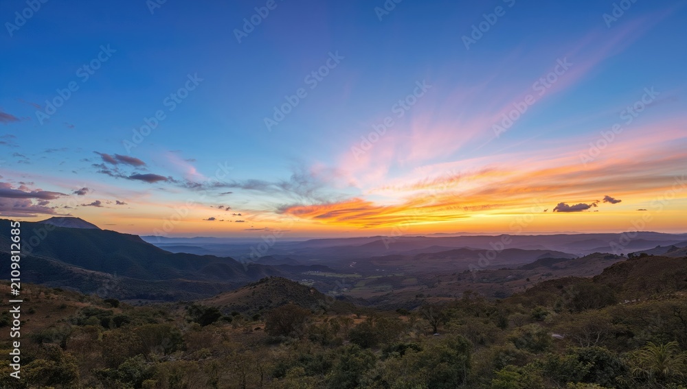 Obraz premium Vibrant Sunset Over Rolling Hills - Panoramic View, Serene Nature, Warm Colors
