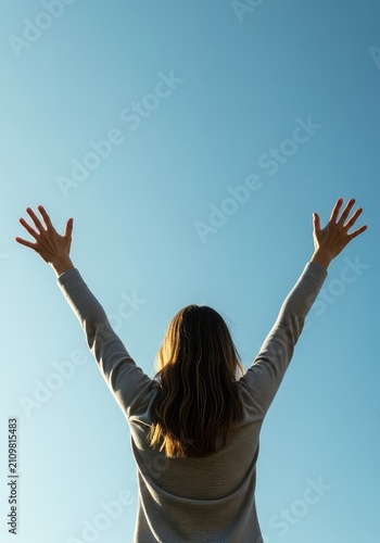 Exuberant and pure joy demonstrated by raised arms against a brilliant sky, symbolizing ultimate success and emotional peak ,outdoors ,motion ,vibrant