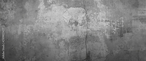 Textured gray concrete wall with cracks and wear