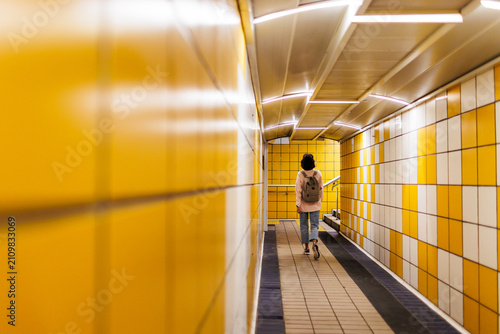 Travel concept. Woman traveler tourist walking with backpack at station.