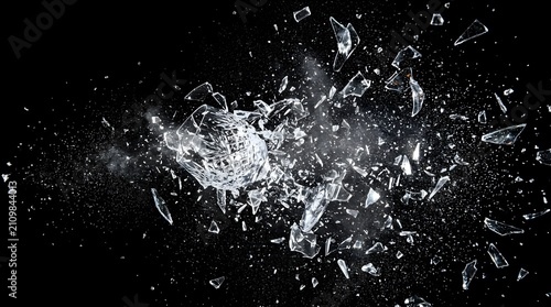 Violent destruction of a glassware item showing fine crystal particles and sharp debris floating in midair with glassware, shattered