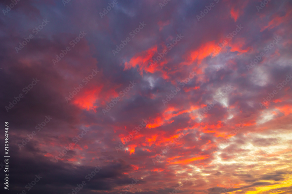 Fototapeta premium Partly cloudy sunset sky. Dramatic orange sky background.