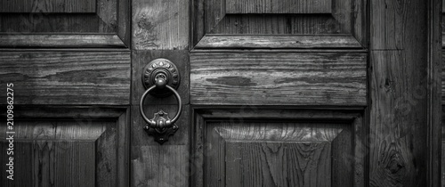Antique Wooden Door with Knocker - Close-Up, Black and White, Textured Detail