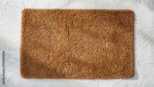 tan plush rug placed on whi...