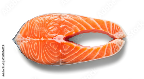 Fresh raw salmon steak isolated on white background ready for healthy cooking.