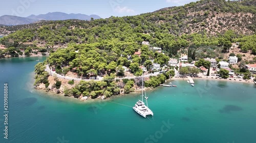 Cinematic Left Orbit Drone Shot Around Catamaran in Turquoise Bay Near Poros, Greece on Bright Midday July Yacht Week