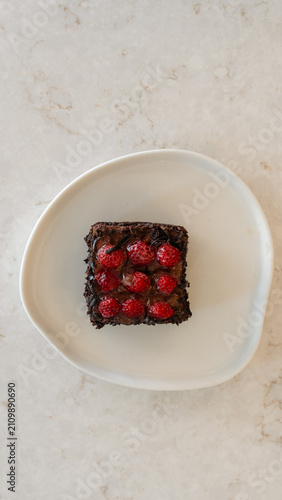 Rich Chocolate Cherry Cake Square: A delectable square slice of rich chocolate cake, adorned with a generous topping of fresh cherries and a crumble of dark chocolate.