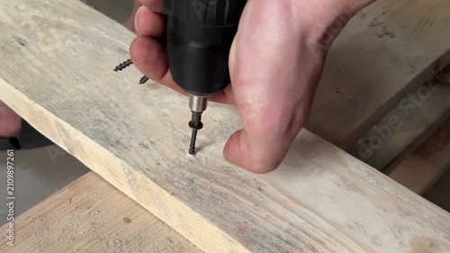 fastening wooden boards with a self-tapping screw . High quality 4k footage