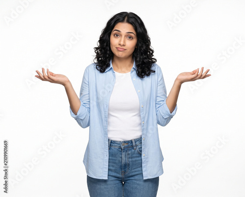 young indian woman making shrug gesture expressing uncertainty confusion and no idea isolated on white background
