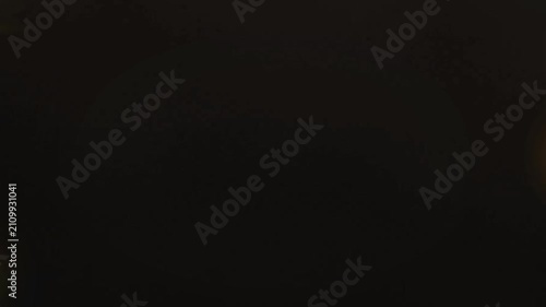 Abstract flowing bokeh lights in warm gold and brown tones, soft focus background texture for festive or elegant themes