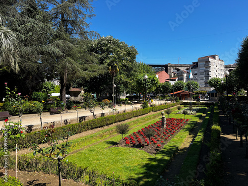 Public park garden with red flower beds in Redondela, Spain