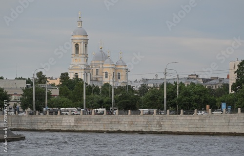 A wide-angle view of the historic Prince Vladimir Cathedral standing behind green trees in St. Petersburg. Good for travel guides, historical articles, educational materials, tourism marketing cam
