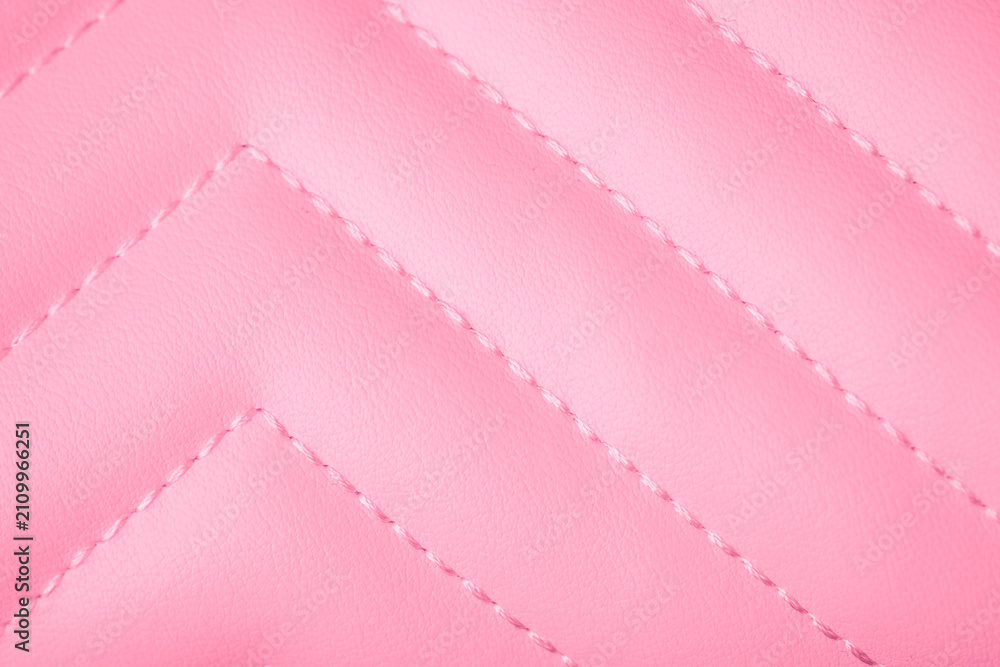 Obraz premium Pink soft textured quilted surface with diagonal stitching creating a repetitive chevron design