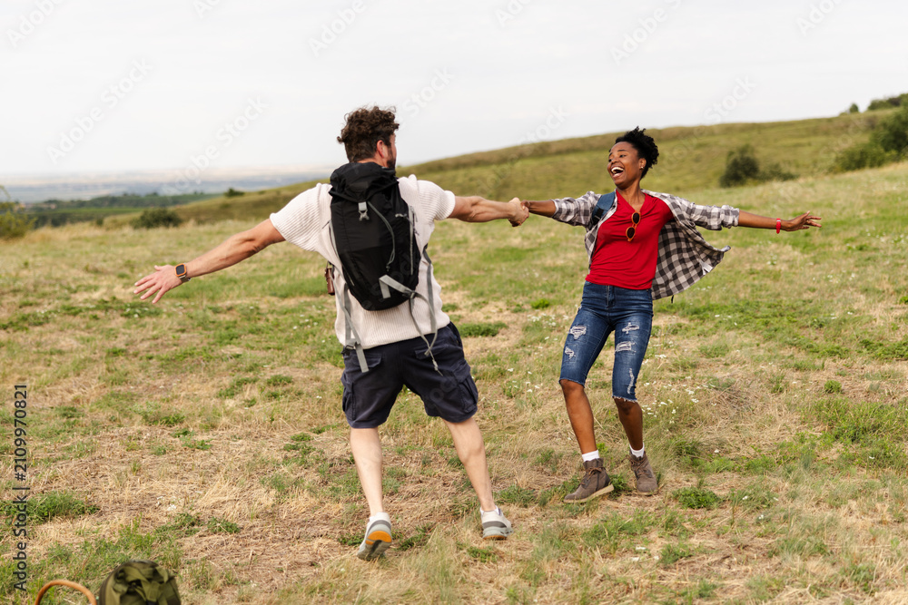 Fototapeta premium Enjoying Time Outdoors With Friends in a Grassy Field During a Sunny Day