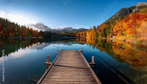 Autumn Mountain Lake With Wooden Dock And Colorful Foliage