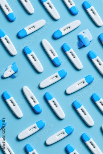 Pattern of Pregnancy Tests on a Blue Background.