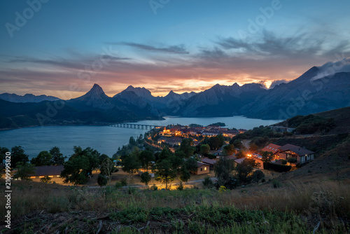 Photos Riaño Reservoir with the city lit up at night, León, Castile and León, Spain