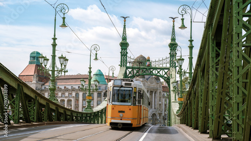 Explore the charm of Budapest with a vintage tram crossing the iconic Liberty Bridge