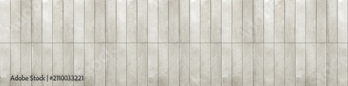 Light grey ceramic finger tiles arranged vertically with a subtle textured surface and neat grout.