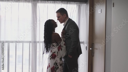 Cuadro en lienzo A pair of lovers tenderly and passionately look at each other near a large window