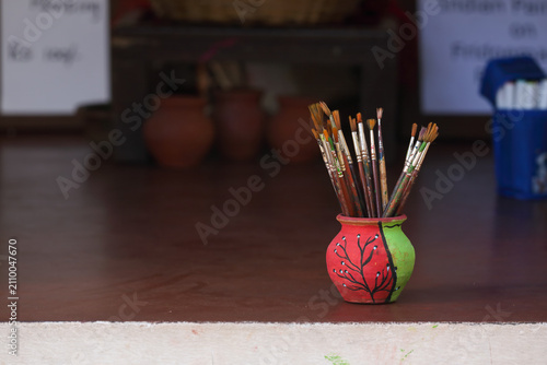 Paint brushes at artist workplace