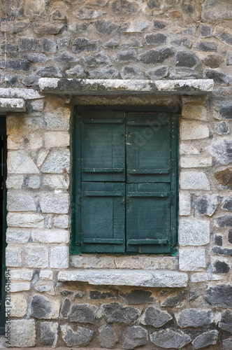 Traditional old wooden window in stone wall