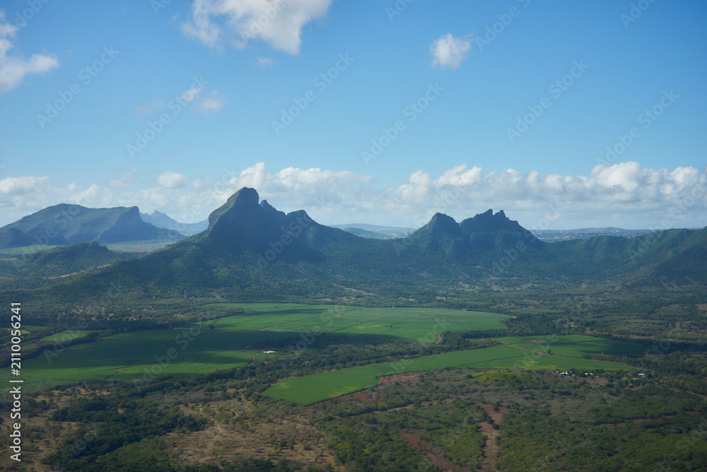 Obraz premium A gorgeous mountain landscape of Mauritius featuring lush green peaks, dramatic ridges, and breathtaking tropical scenery. The image showcases the island's volcanic terrain, natural beauty, and views