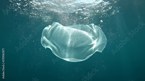 Large Air Bubble Rising Gracefully Through Deep Blue Underwater Environment.