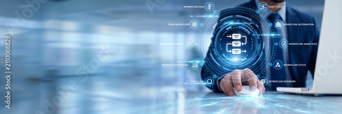 Obraz na płótnie Businessman using a laptop for Workflow data analysis, mapping procedural corporate task automation paths, monitoring operational pipeline handoffs, and eliminating team production friction points