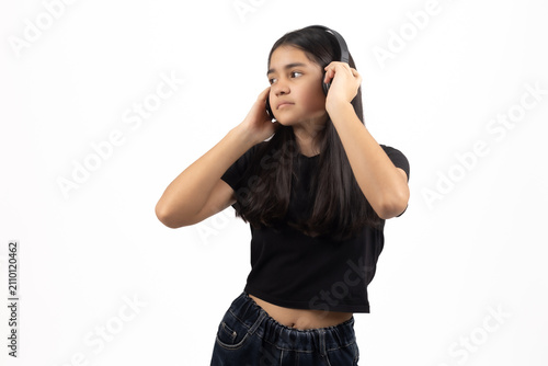 Young woman listening intently while putting hands to ears in room