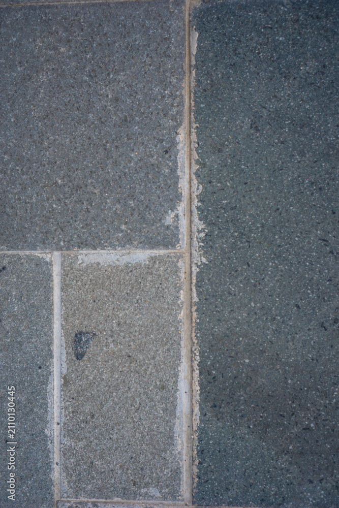 Fototapeta premium Dark stone tiles line a paved surface