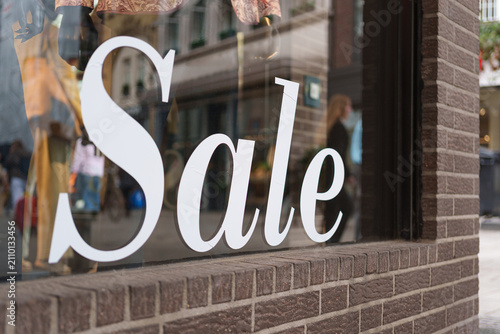 Large sale decal on a boutique window attracting shoppers in Dusseldorf city center