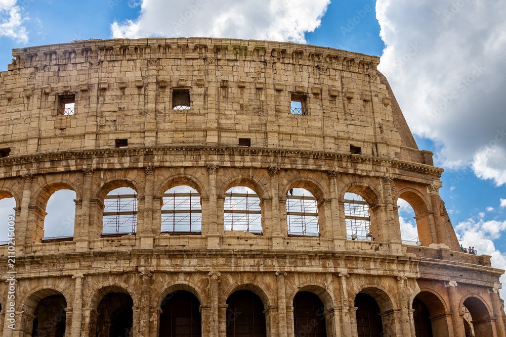 Fototapeta premium Famous tourist attraction of historic Colosseum amphitheatre with ancient stone arches in Rome Italy