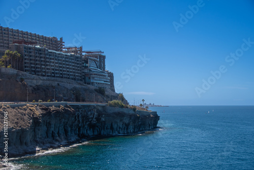 Coastal cliffs and resort hotel overlooking the Atlantic Ocean in Puerto Rico, Gran Canaria
