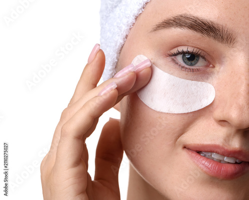 Фотография Beautiful woman with eye patch on white background, closeup