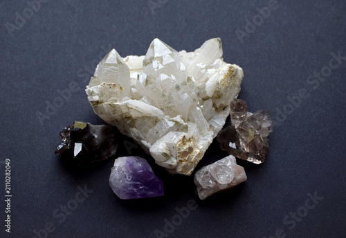 Rock crystal and smoky quartz druze on a gray background. Semi-precious natural stones for magic and meditation. Healing crystals.
