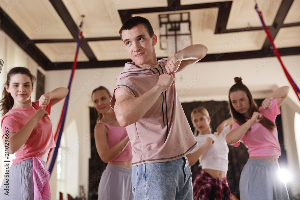 Obraz premium Group of dancers practicing dance moves in studio, low angle view
