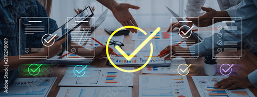 Fotografie Dynamic office scene depicting a motivated team engaged in productive discussions, with digital check marks symbolizing approval and success in their collaborative projects