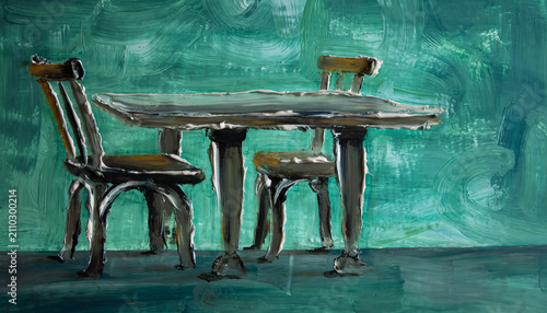 Vintage wooden table and chairs against a green wall.