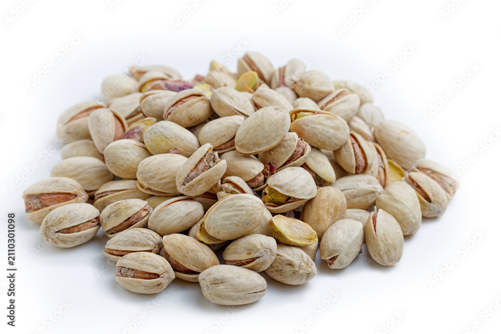 Fototapeta premium Pistachio nuts forming pile on white background
