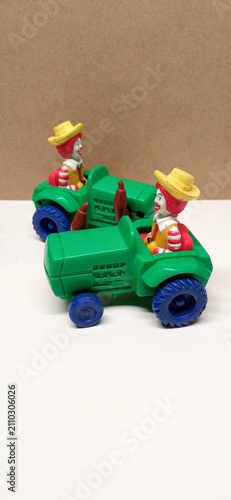 Фотография Vintage Plastic Clown Tractor Toys on Neutral Background mac donald