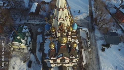 Drone lowering facing snowy church